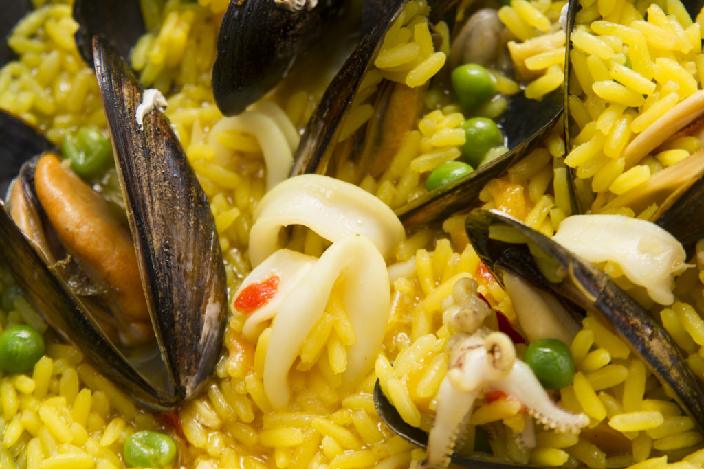 Presentation of a dish of Spain, paella being cooked