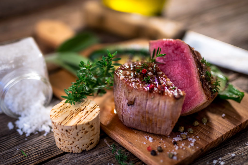 Grilled beef steak on wooden cutting board