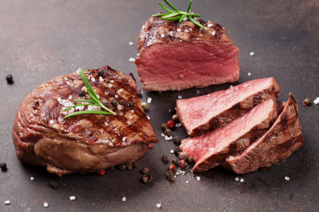 Grilled fillet steaks on stone table