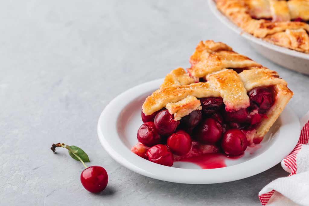 Homemade Cherry Pie with a Flaky Crust on Grey stone background.