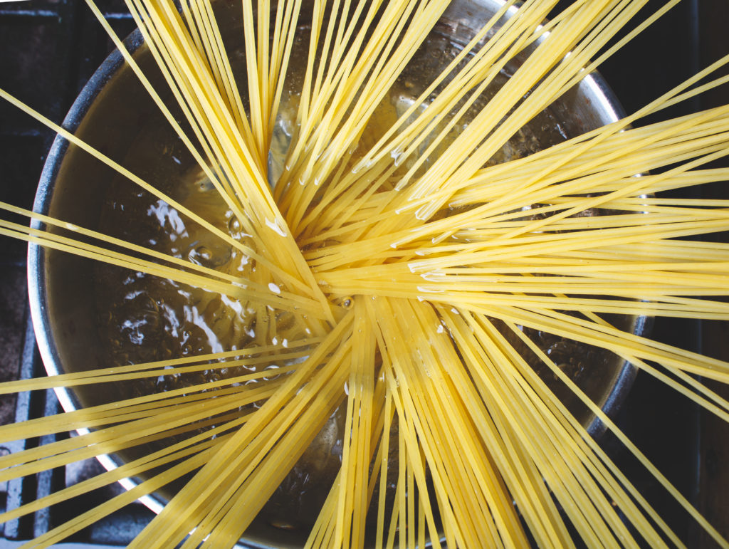 spaghetti pasta is cooked in pan in boiling water