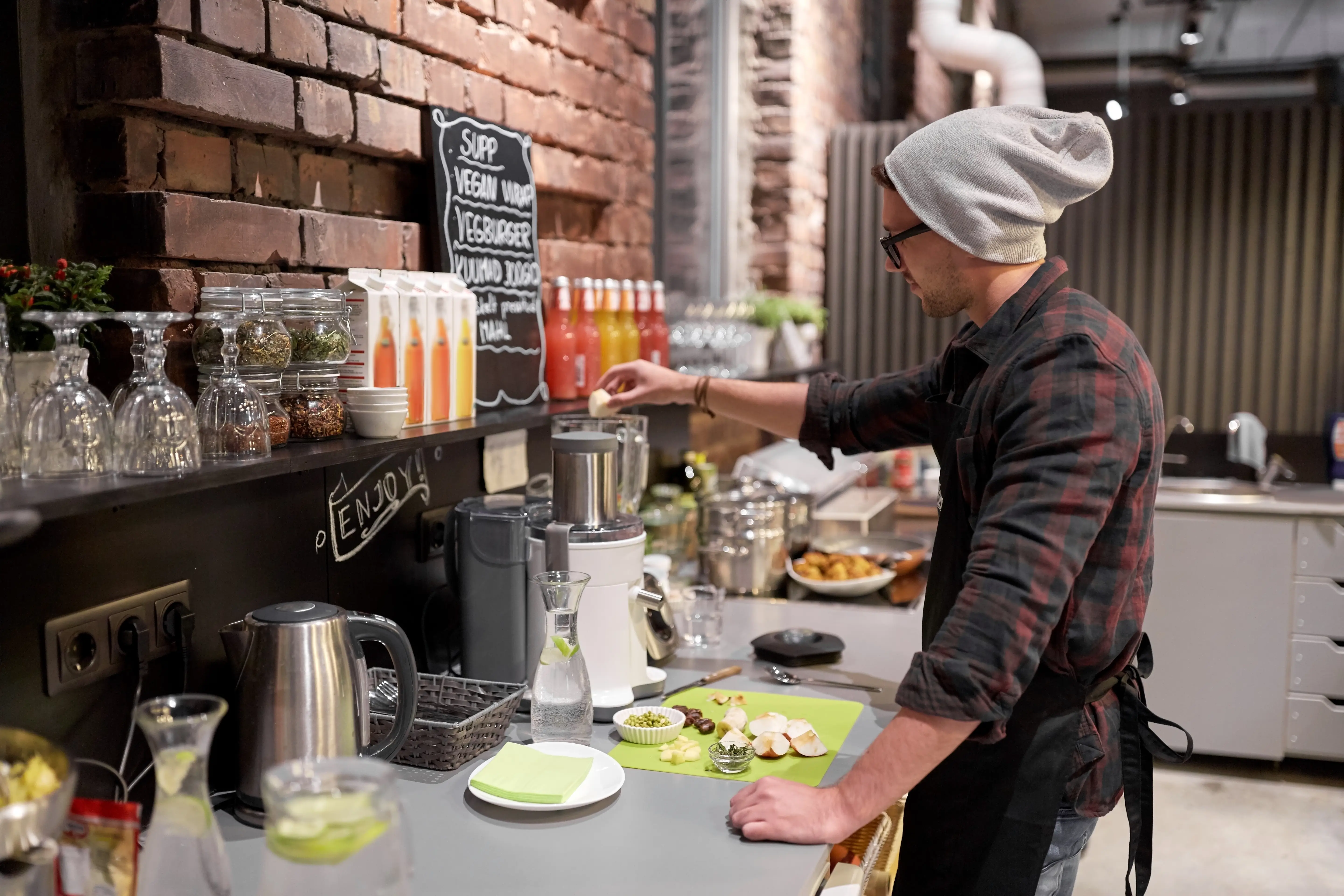 man or barman cooking smoothie at vegan cafe